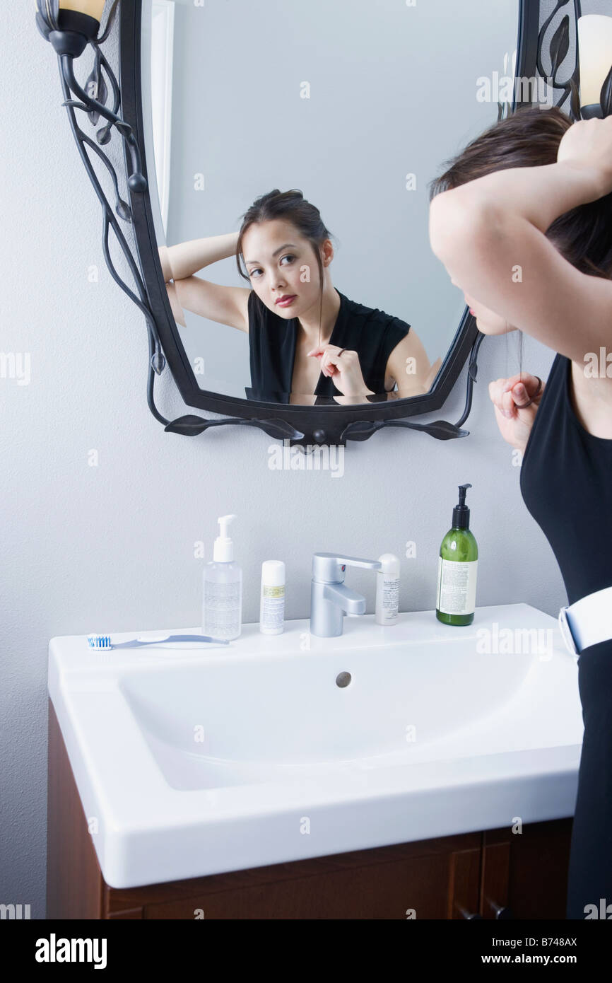 Woman getting ready in front of mirror Stock Photo