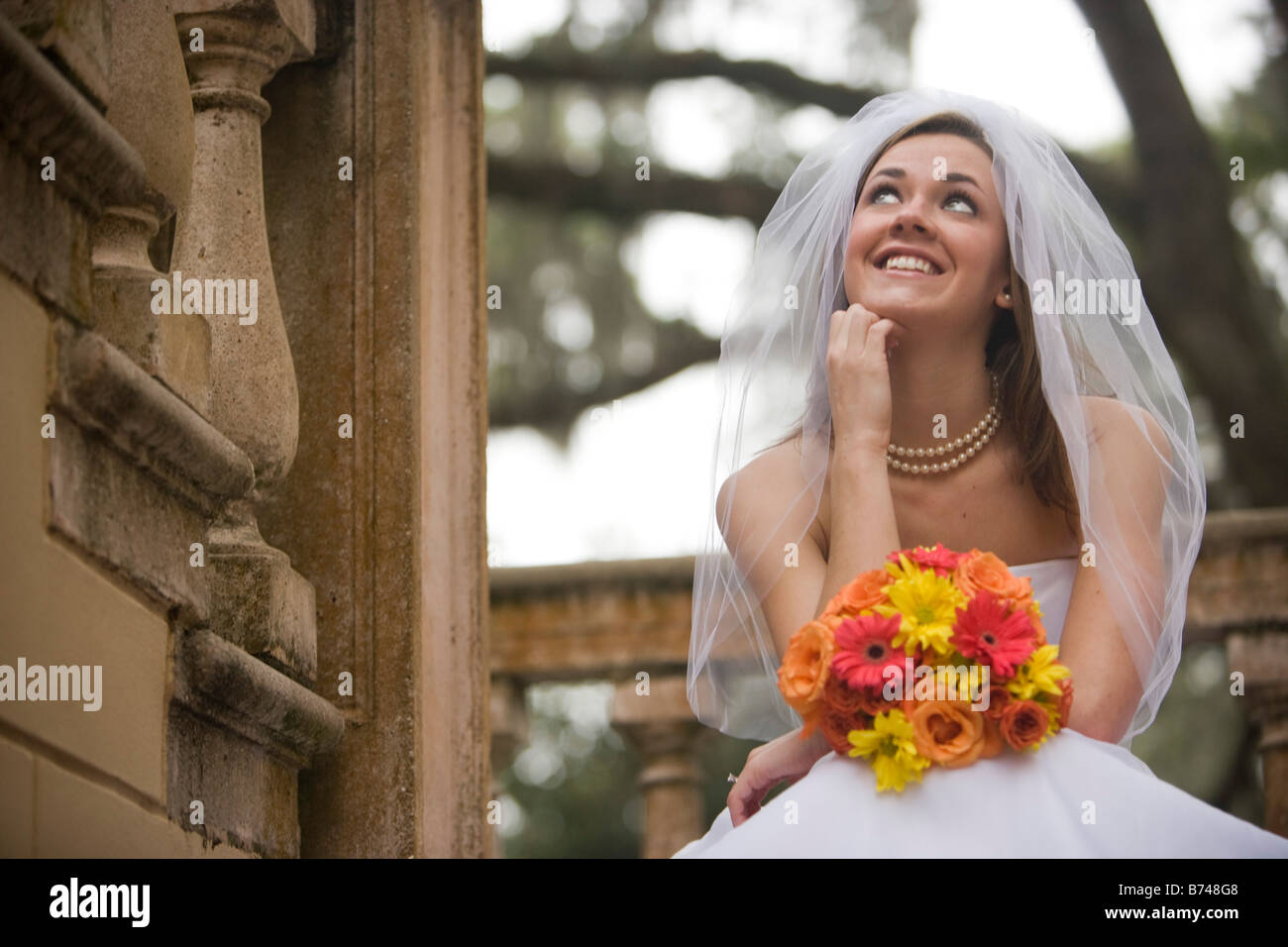 Bride sitting on steps bouquet hi-res stock photography and images - Alamy
