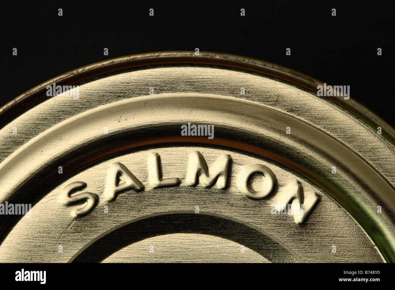Salmon - Steel tin food can container marked Salmon fish produce with black background for copyspace Stock Photo
