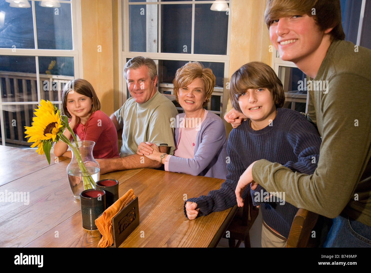 Portrait of family together hanging out in dining room Stock Photo