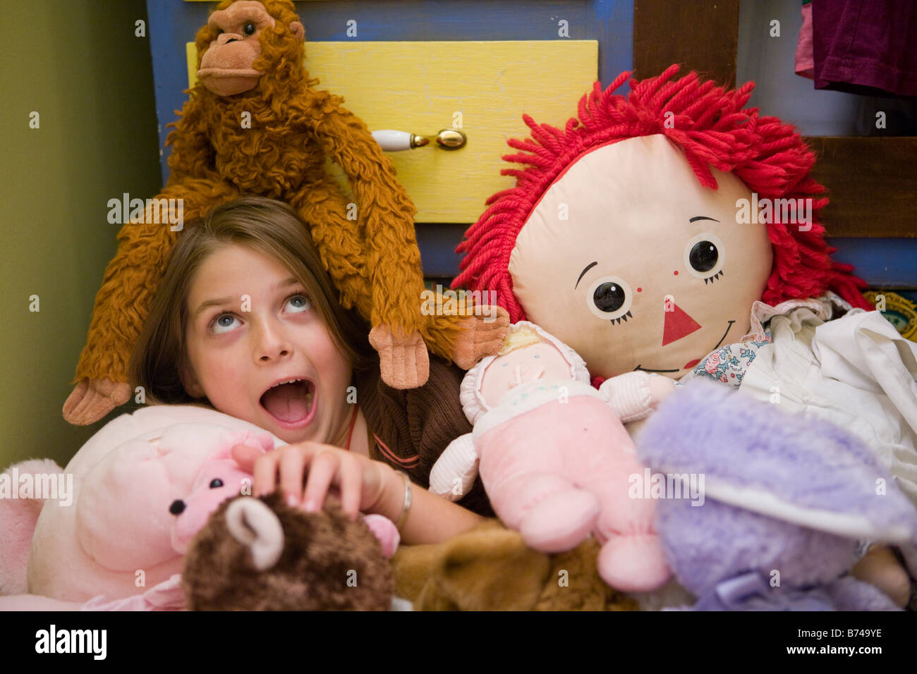 Eight year old girl playing with dolls Stock Photo