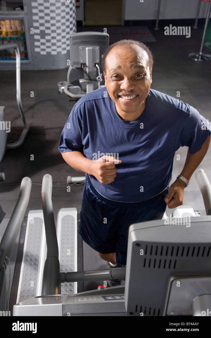 Senior man walking on treadmill at health gym Stock Photo - Alamy