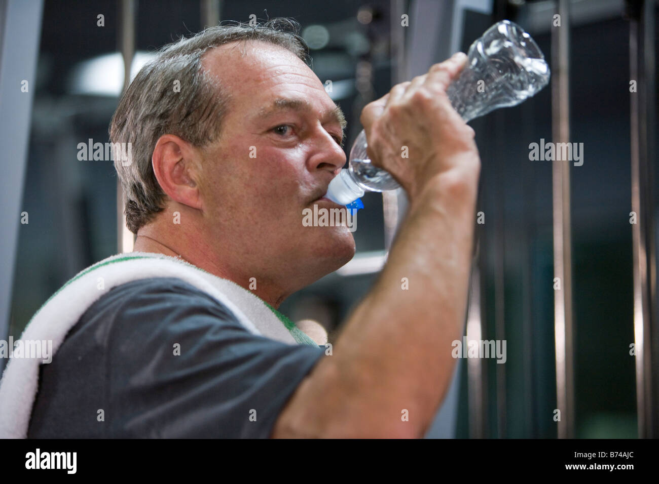 Portrait of senior man drinking water bottle at health gym Stock Photo ...