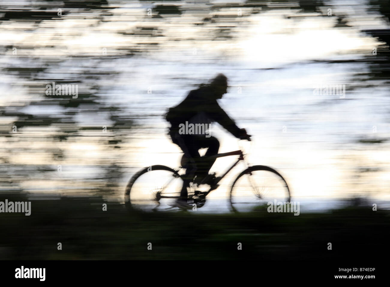 Park morning light man on bike hi-res stock photography and images - Alamy