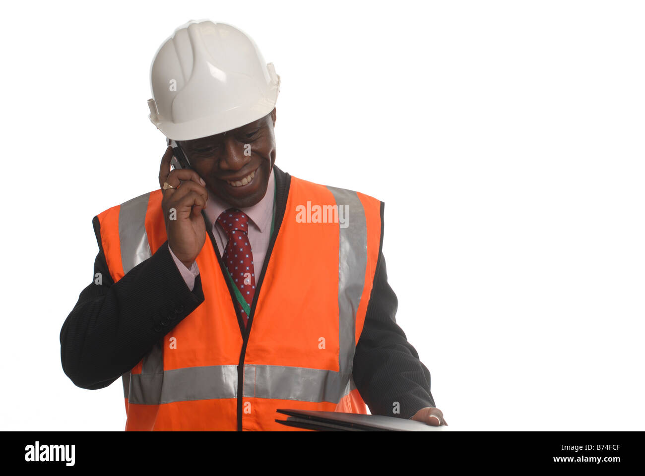 Cut out of a man overseeing building work in a hard hat and hi-viz vest Stock Photo
