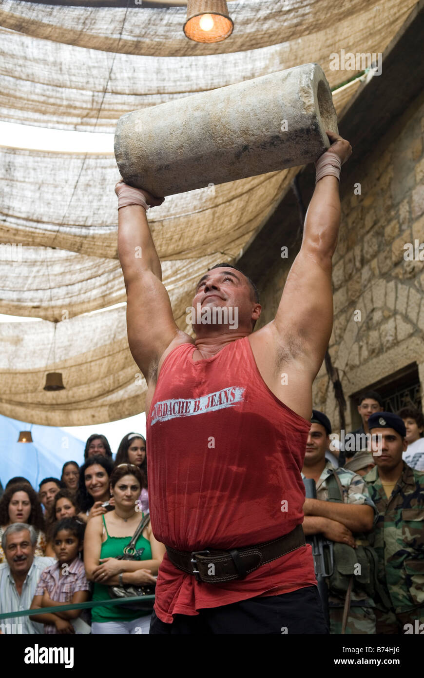 Strong man lifting heavy stone Lebanon Middle East Stock Photo