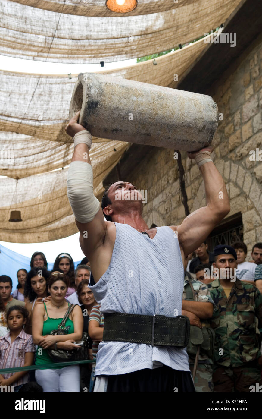Strong man lifting heavy stone Lebanon Middle East Stock Photo