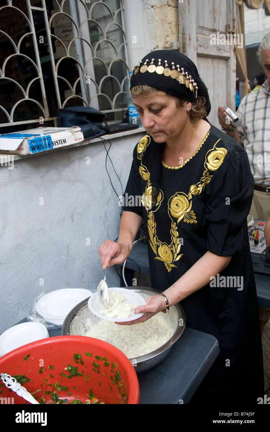 Middle Eastern woman serving homos in food festival Lebanon Middle East Stock Photo