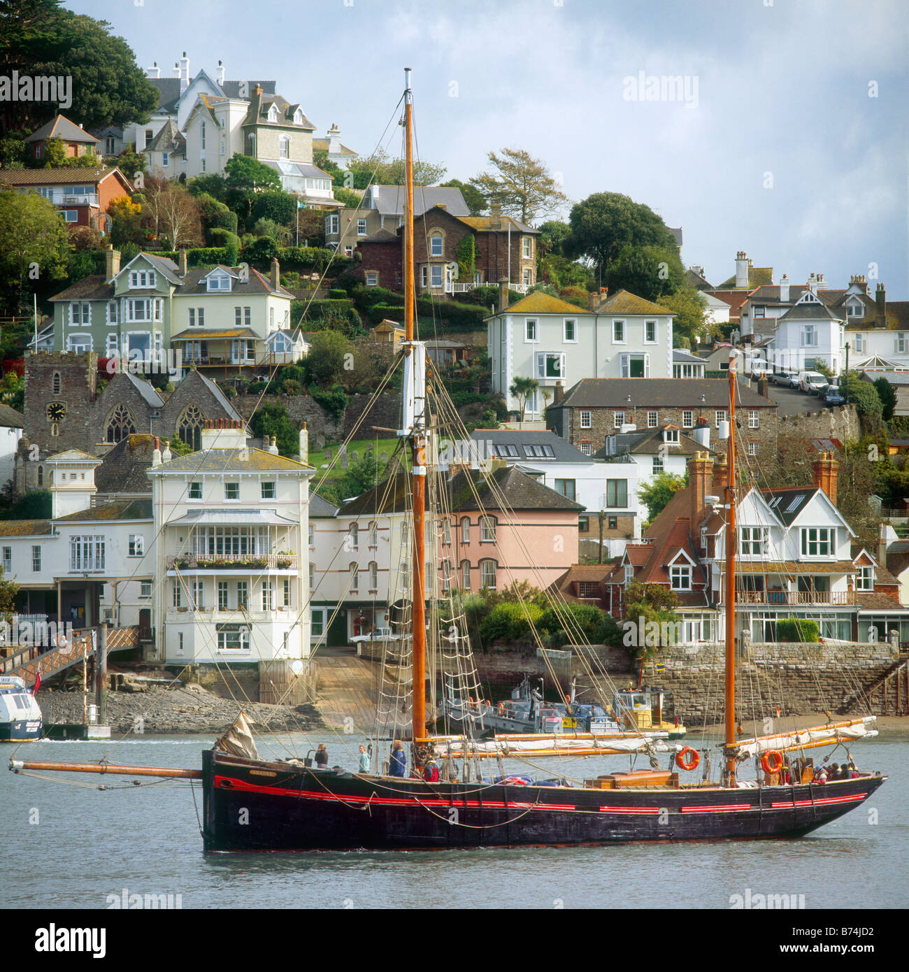 'Leader', a former Brixham sailing trawler, operated by Trinity Sailing, passes the Lower Ferry at Kingswear jmh Stock Photo