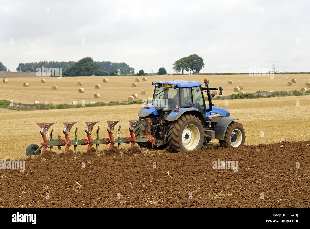 Tractor tilling soil Stock Photo
