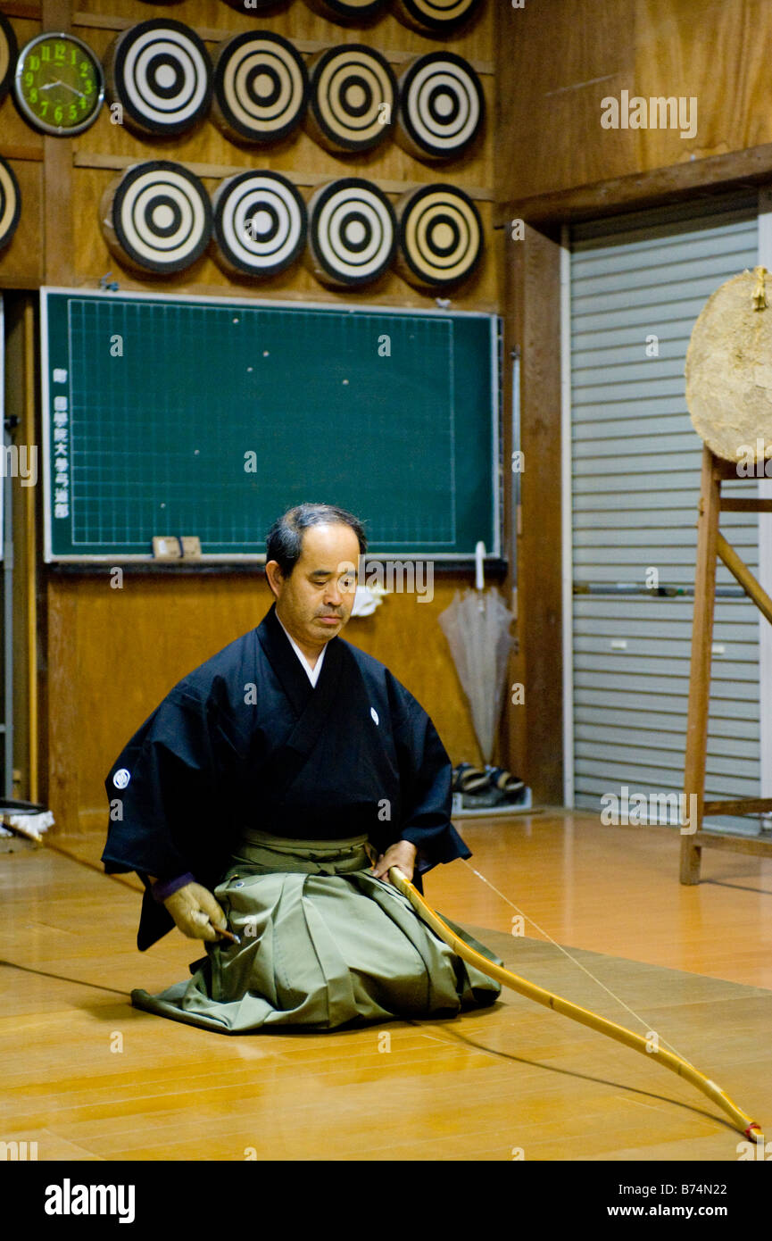 A Kyudoka preparing to string his bow in a Dojo in Yudanaka, Japan Stock Photo Alamy