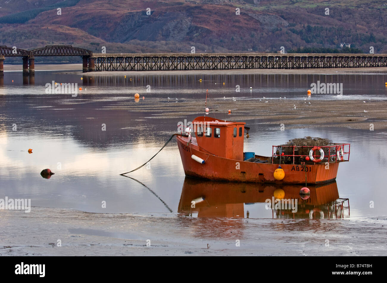 Fishing boat moored up in front of the bridge in Barmouth Harbour Gwynedd North Wales Stock Photo