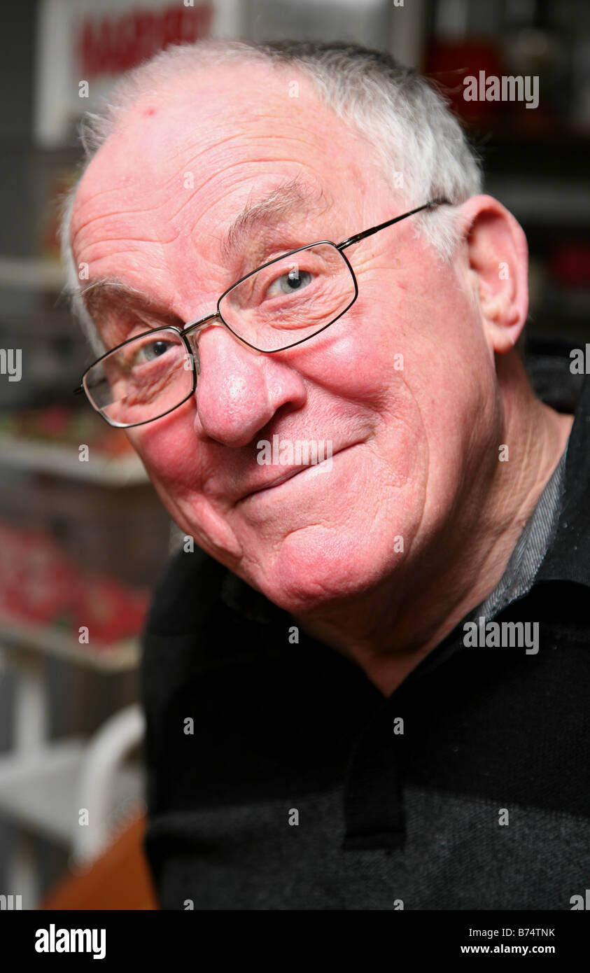 Pensioner smiling wearing glasses Stock Photo - Alamy