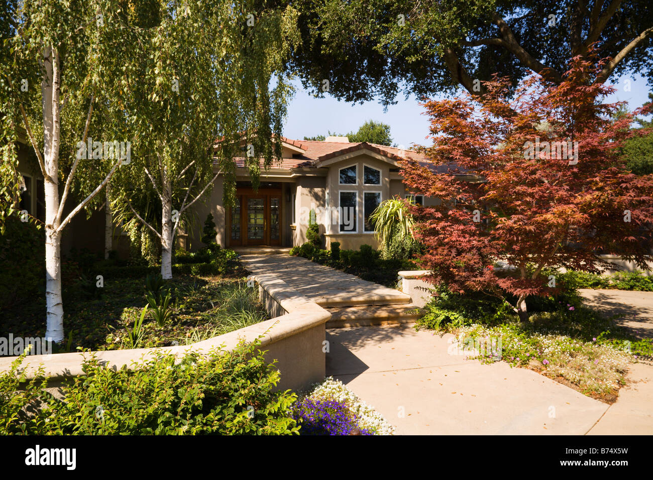 Front walkway and landscaping to Spanish style home Stock Photo Alamy