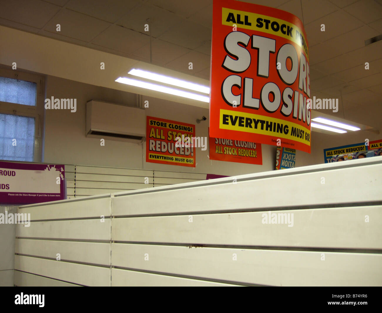 STORE CLOSING / Fixtures & Fittings for sale - signs in a store closing sale due to Liquidation. (Woolworths) Stock Photo