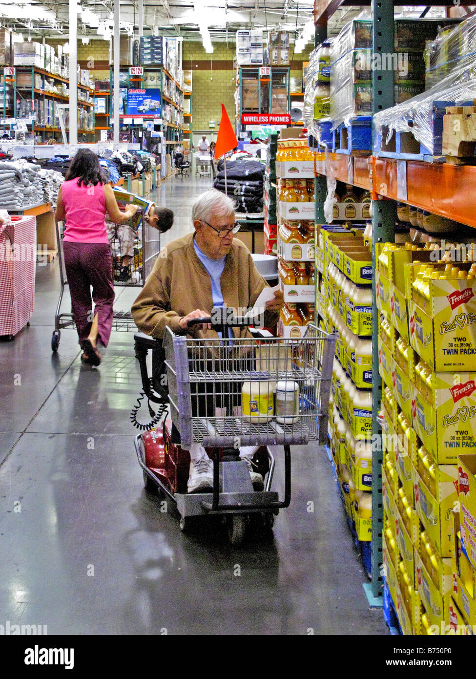 Elder man on wheelchair checking his list while shopping at a big box