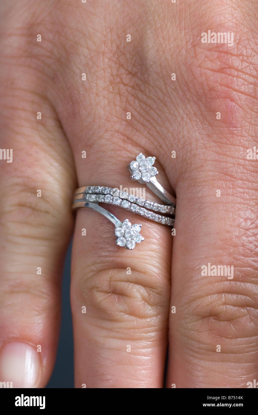 Close up of woman's hand wearing diamond ring Stock Photo