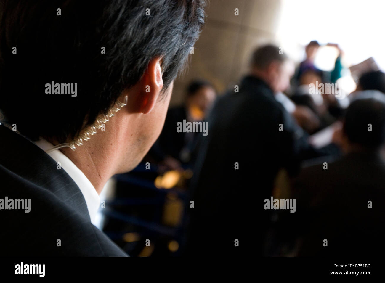 security guard wearing earpiece watching over star celebrity. Stock Photo