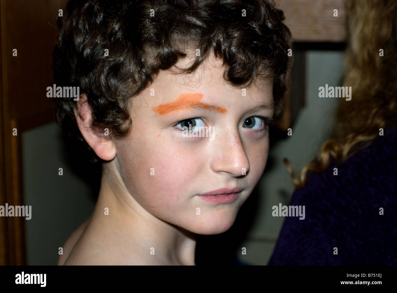 Young boy caught painting his face Stock Photo