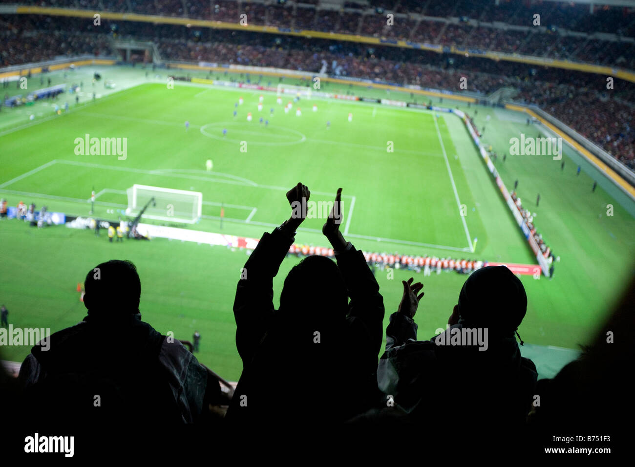 fans at football game cheering a goal being scored, Nissan Stadium , Shin-Yokohama, Japan Stock Photo