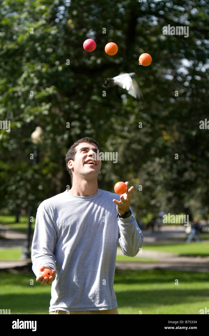 A man toss juggling balls in Boston Common public park in Boston Massachusetts USA Stock Photo