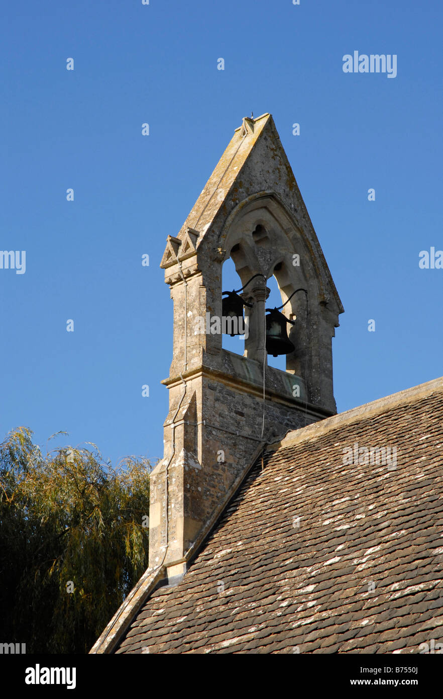 Two bells in bell gable on gable of church wall with cloudless blue sky beyond Stock Photo