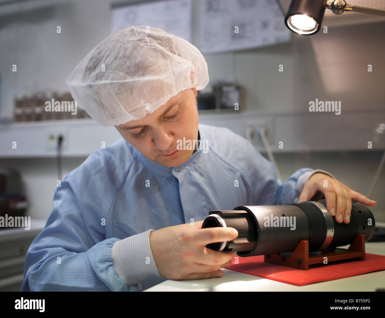 Employee controlling a camera lens at Carl Zeiss AG Jena Stock Photo
