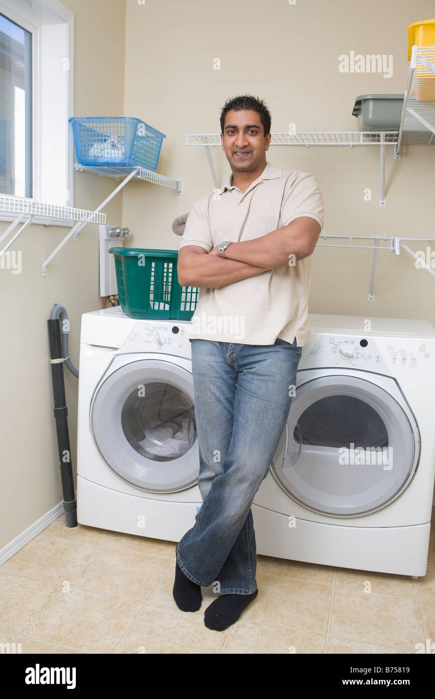 Man stands beside energy and water efficient front loading washing