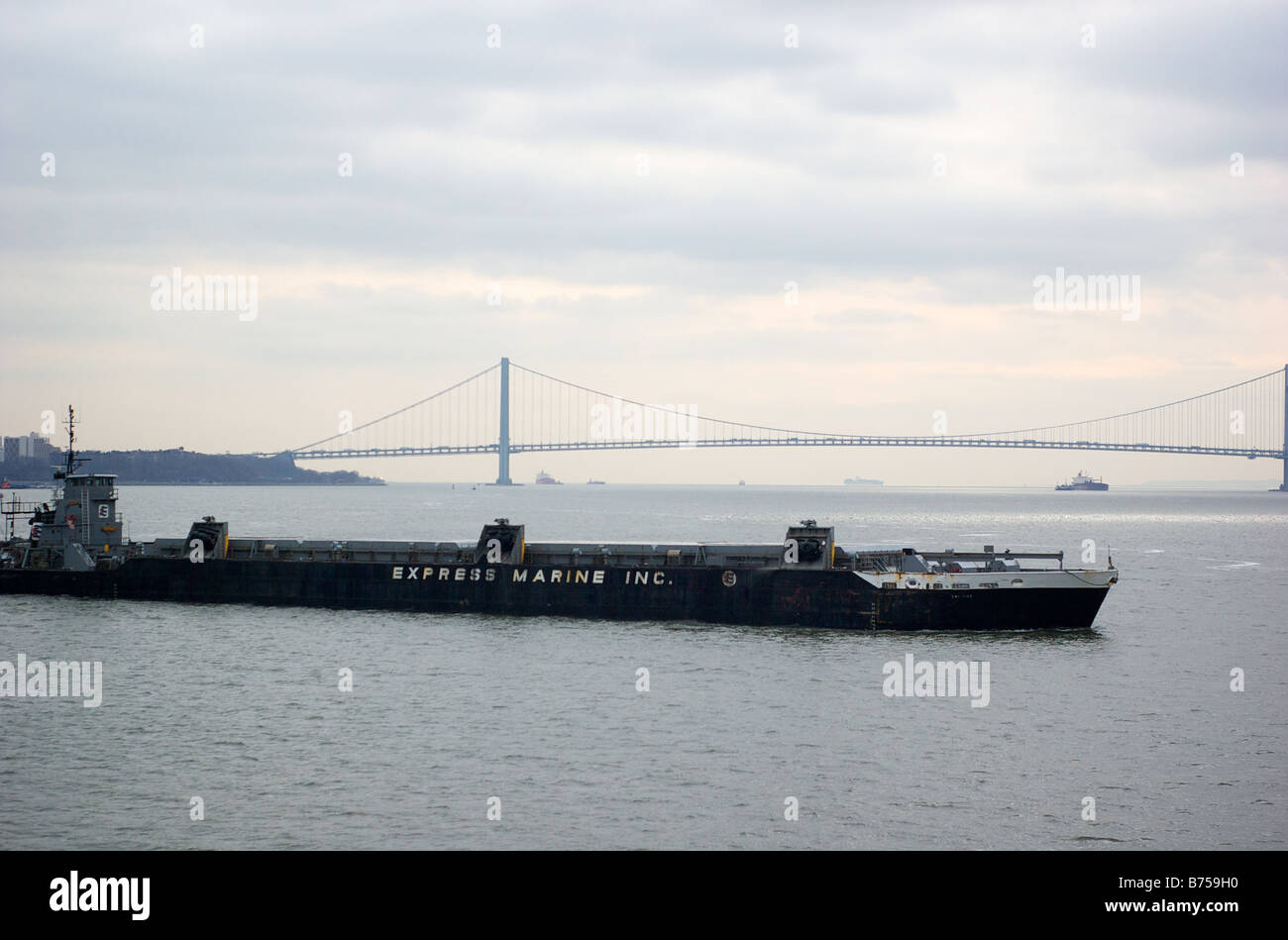 Verrazano Narrows Bridge and Express Marine Barge in Upper New York Bay USA (For Editorial Use Only) Stock Photo