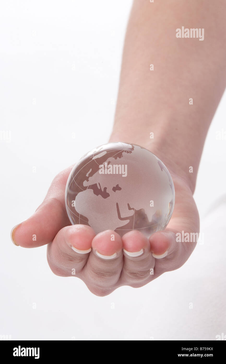 Female hand holding a globe, Winnipeg, Manitoba Stock Photo