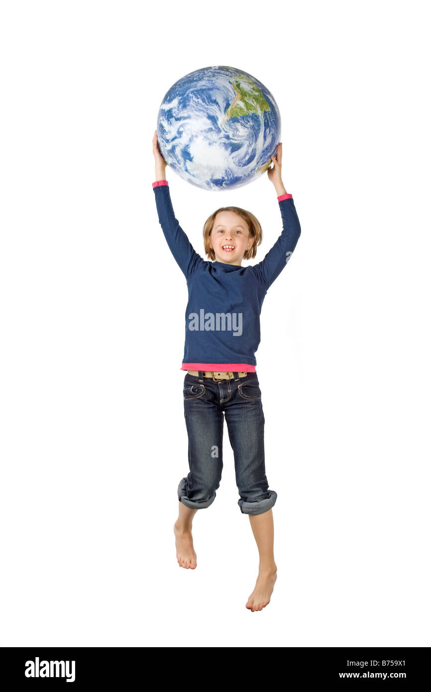 9 year old girl jumping with the globe, Winnipeg, Manitoba Stock Photo