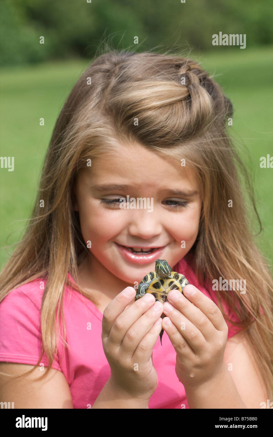 Six year old girl holding turtle, Winnipeg, Canada Stock Photo