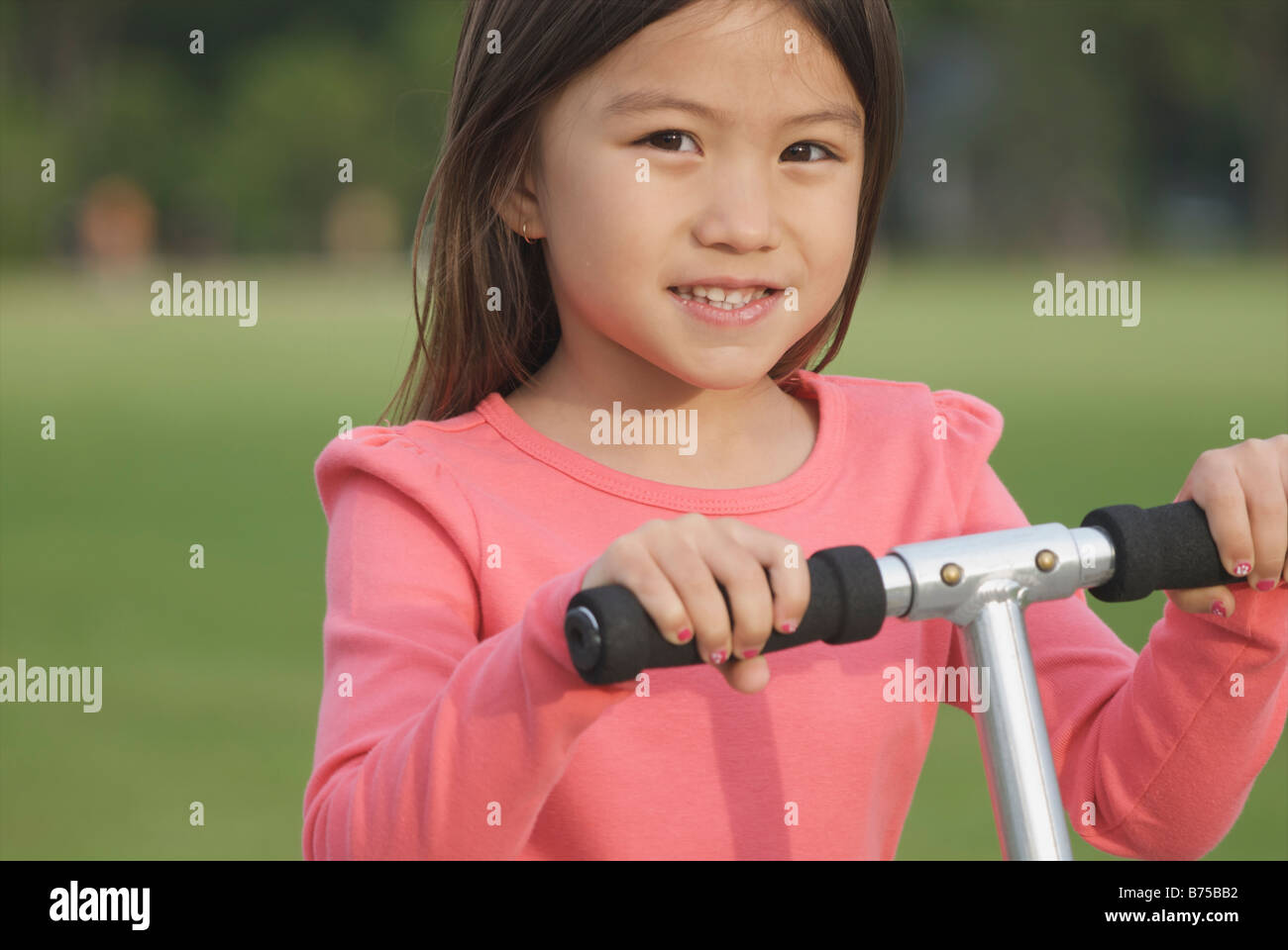 Six year old girl on scooter, Winnipeg, Canada Stock Photo