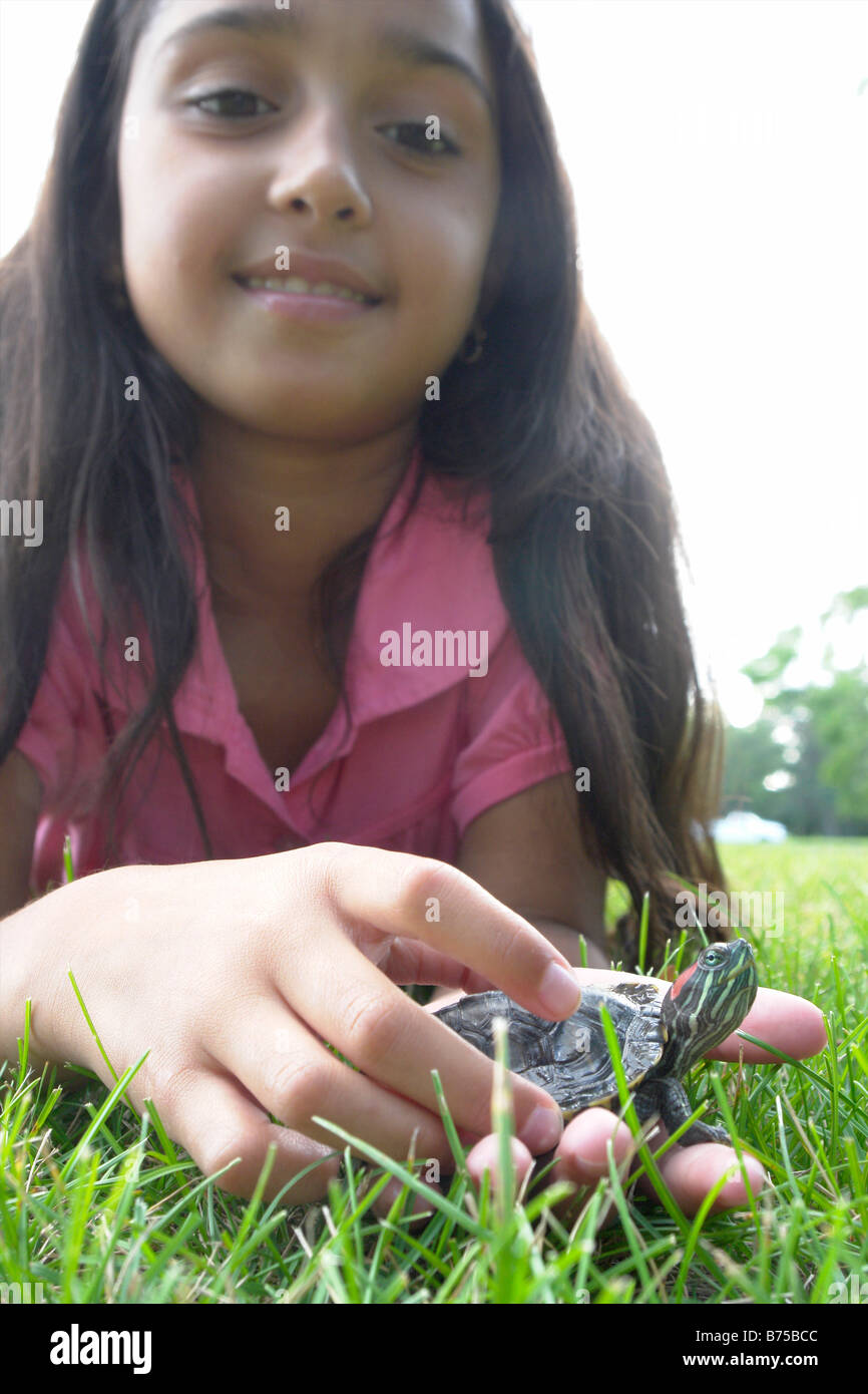 Eight year old girl holding turtle, Winnipeg, Canada Stock Photo