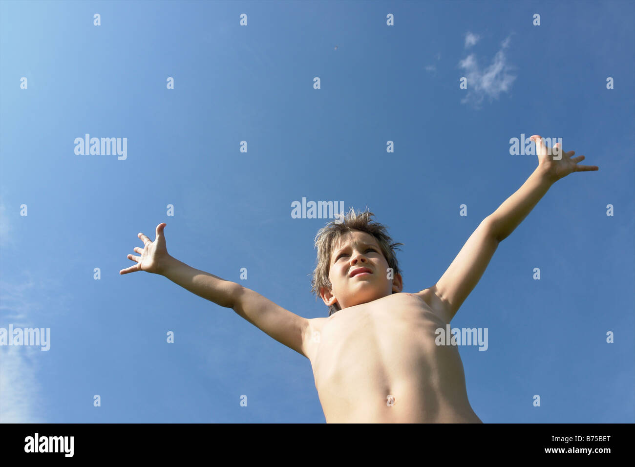 Eight year old boy with arms outstretched, Winnipeg, Canada Stock Photo