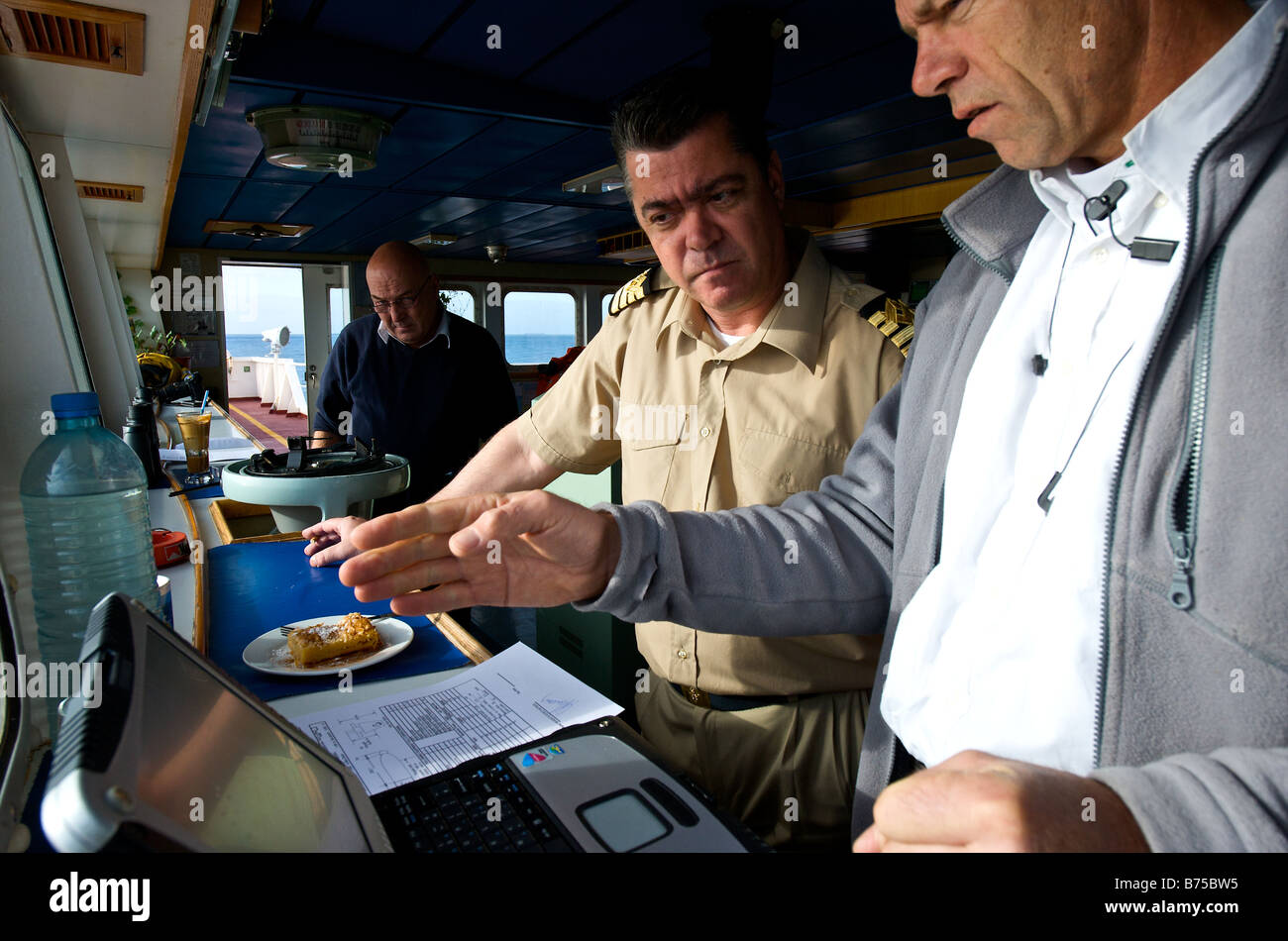 Marine pilot on the bridge of a bulk carrier giving instructions to the