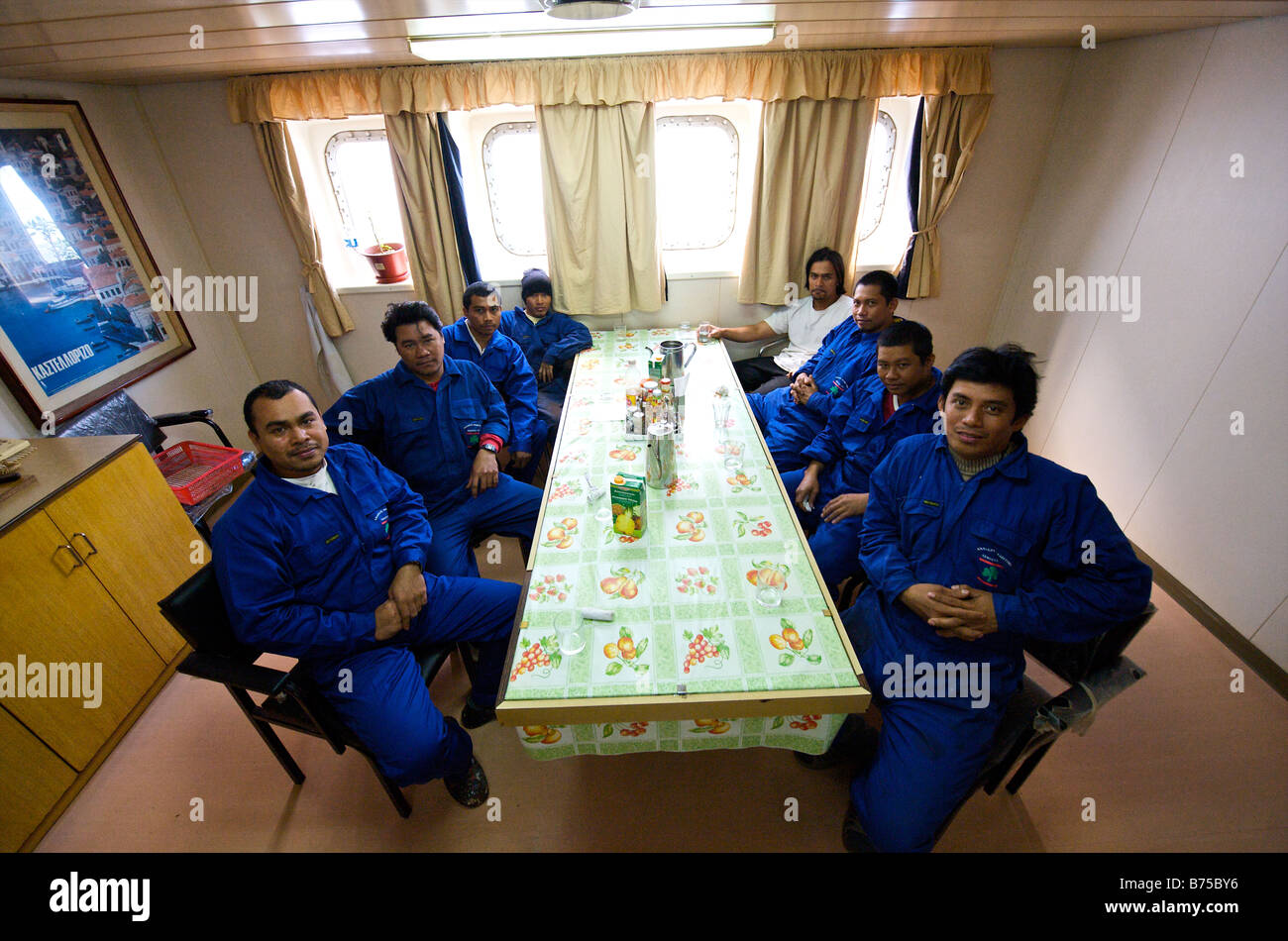 Crew of bulk carrier in the messroom waiting for food being served Stock Photo