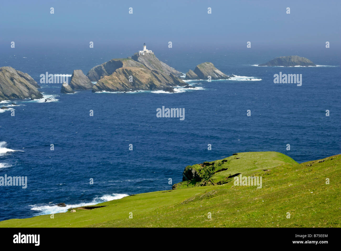 Muckle Flugga lighthouse most northerly lighthouse of Great Britain situated on offshore cliff seen from Hermaness Nature Reserv Stock Photo