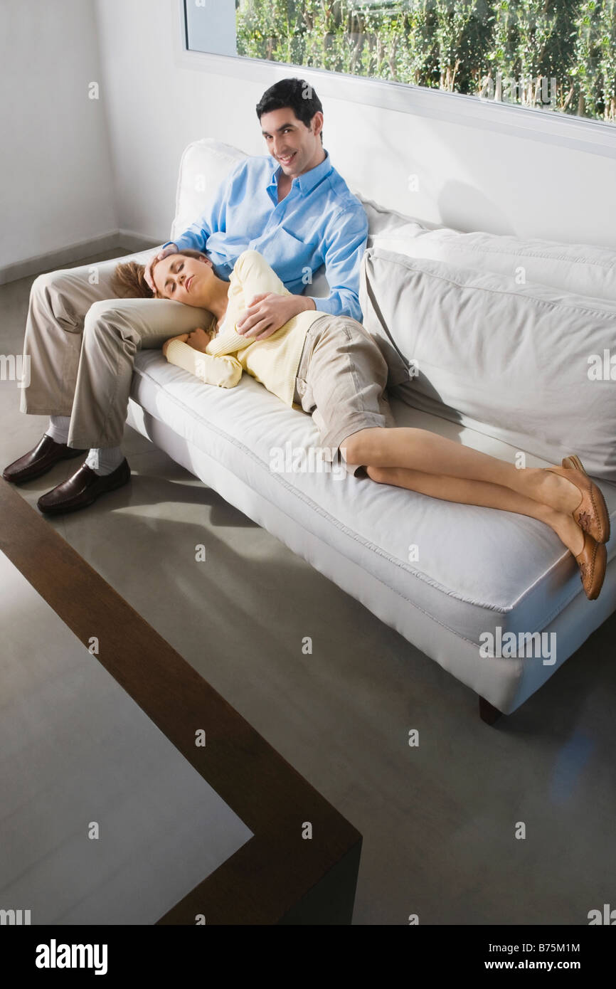 Mid adult woman sleeping on a mid adult man's lap Stock Photo - Alamy