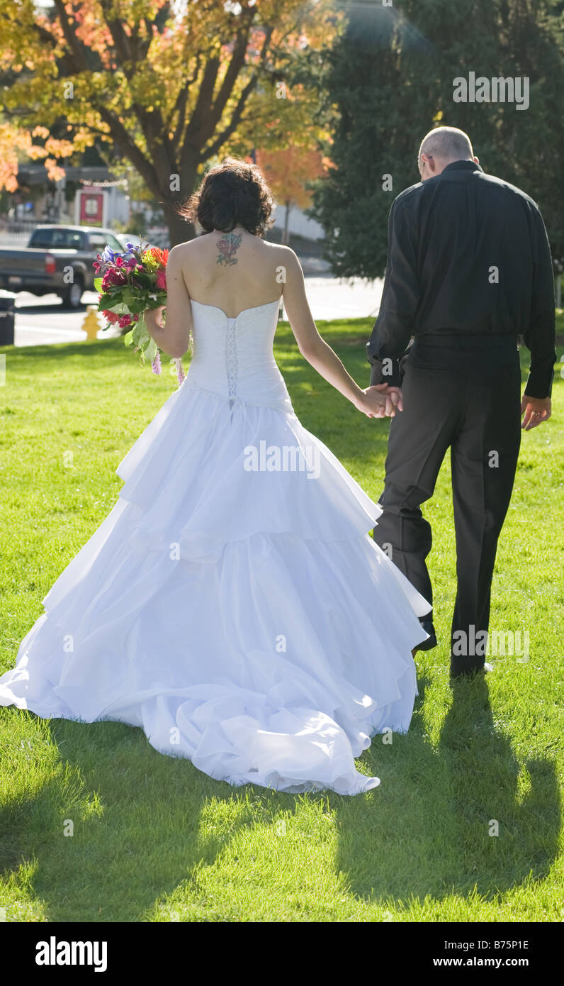 Bride and Groom walking hand in hand Stock Photo - Alamy