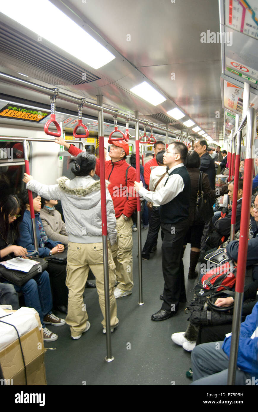 Crowded carriage, MTR Underground Railway, Tsim Sha Tsui, Kowloon Peninsula, Hong Kong, People's Republic of China Stock Photo