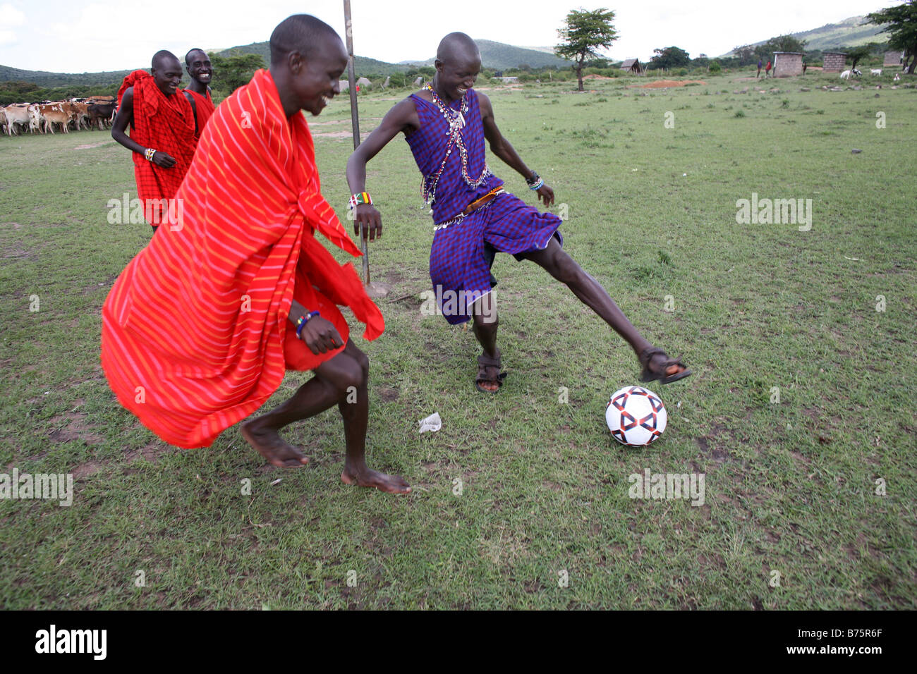 Football is opne of the most popular activities among the Massai tribe in south kenya Whenever their cows are brought in the vil Stock Photo