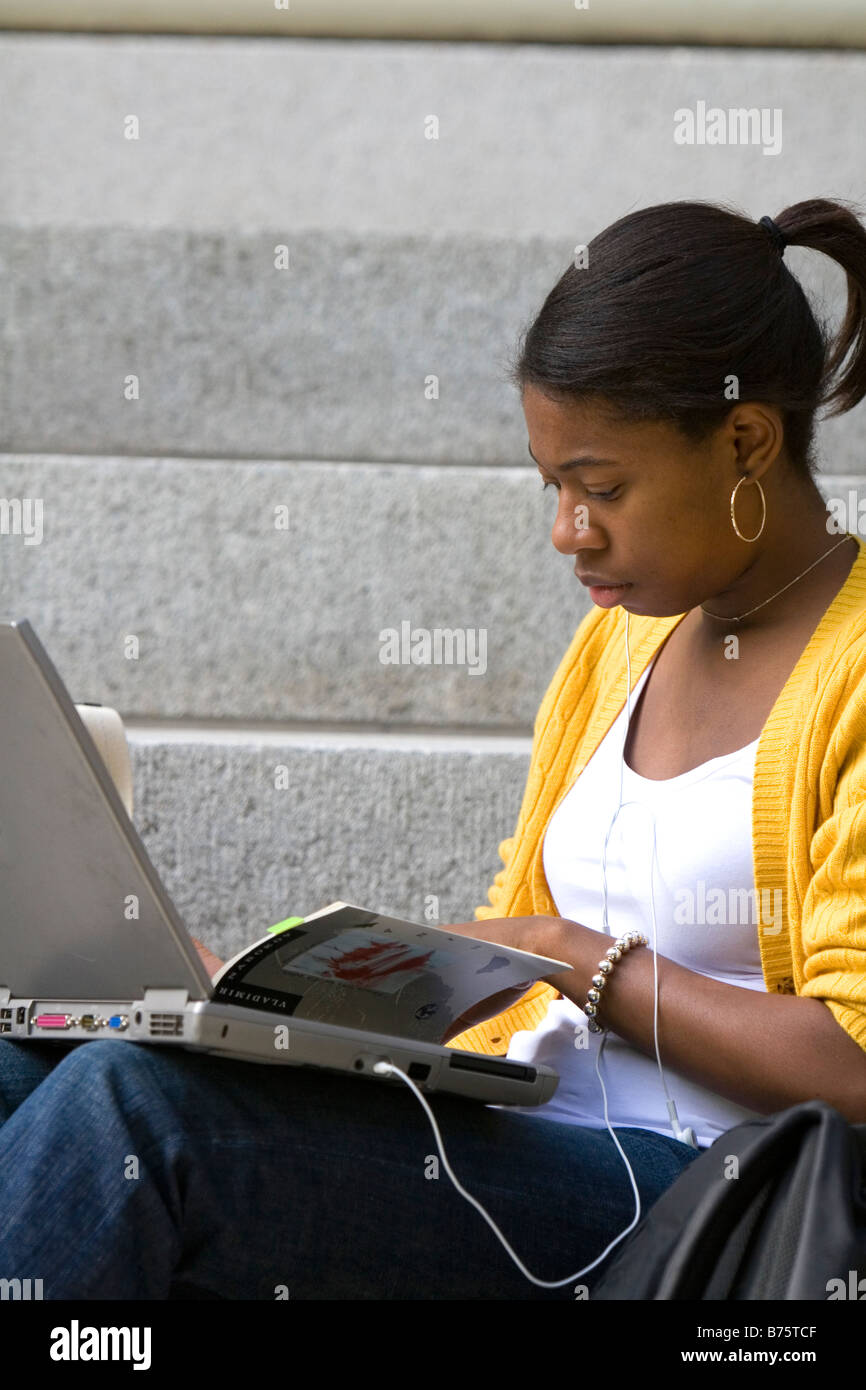 Female student studying with a laptop on the campus of Harvard University in Cambridge Greater Boston Massachusetts USA Stock Photo
