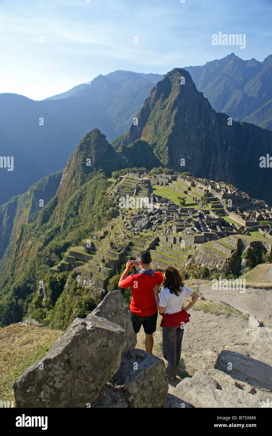 Hikers overlooking the Inca ruins at Machu Picchu Peru Stock Photo - Alamy