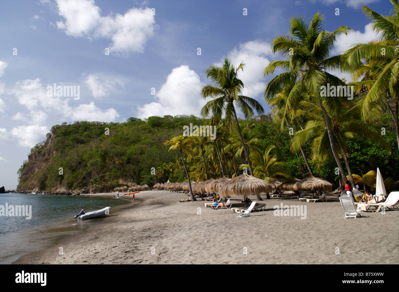 Tourists relax on a stretch of beach at Anse Chastenet, St Lucia, Caribbean. Stock Photo