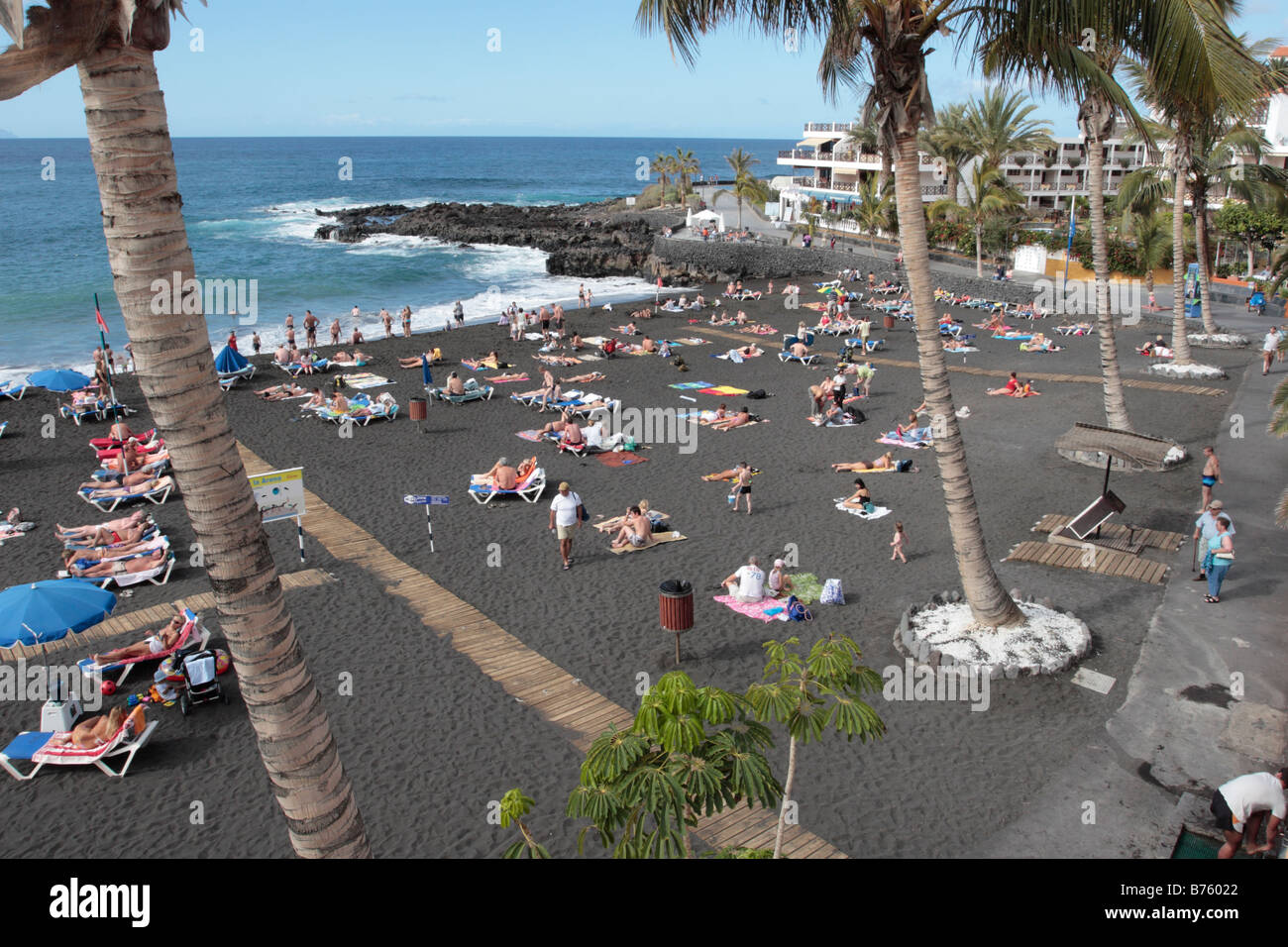 Tourists sunbathing in December on the beach of Playa Arena Tenerife