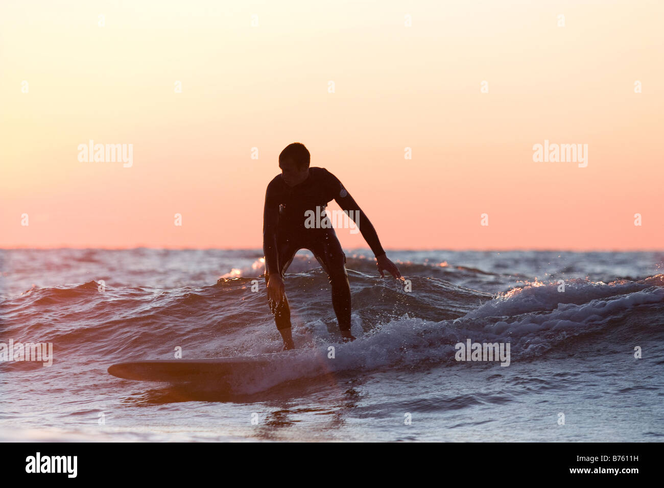 Experienced surfer riding small wave on Lake Michigan Stock Photo