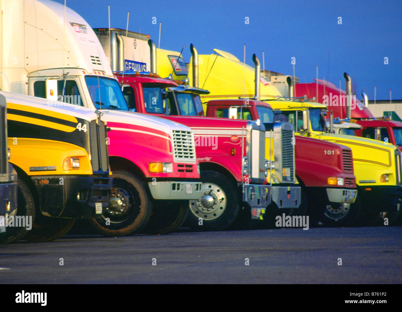 a row of tractor trailer trucks Stock Photo