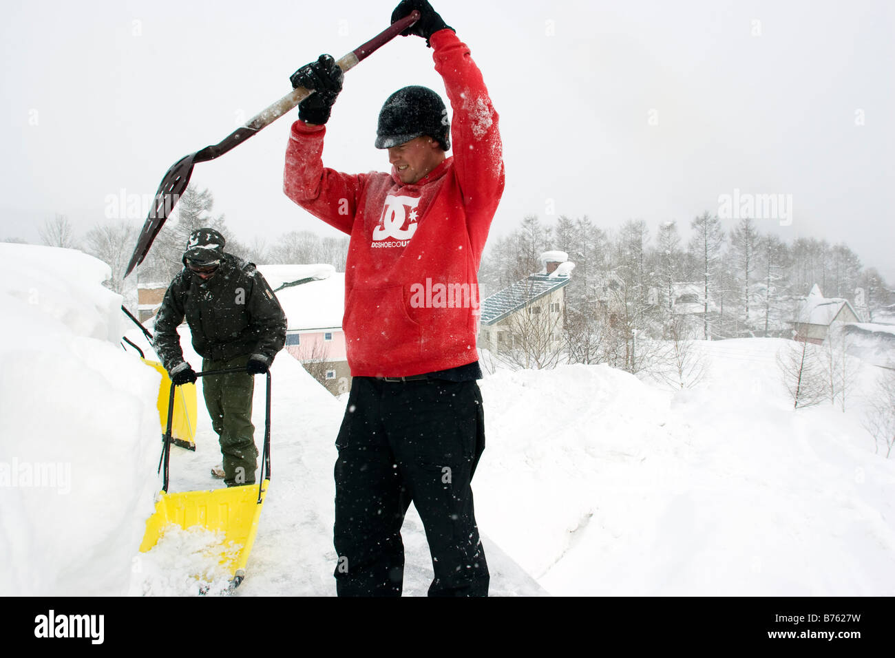 Two men shovel snow off hi-res stock photography and images - Alamy