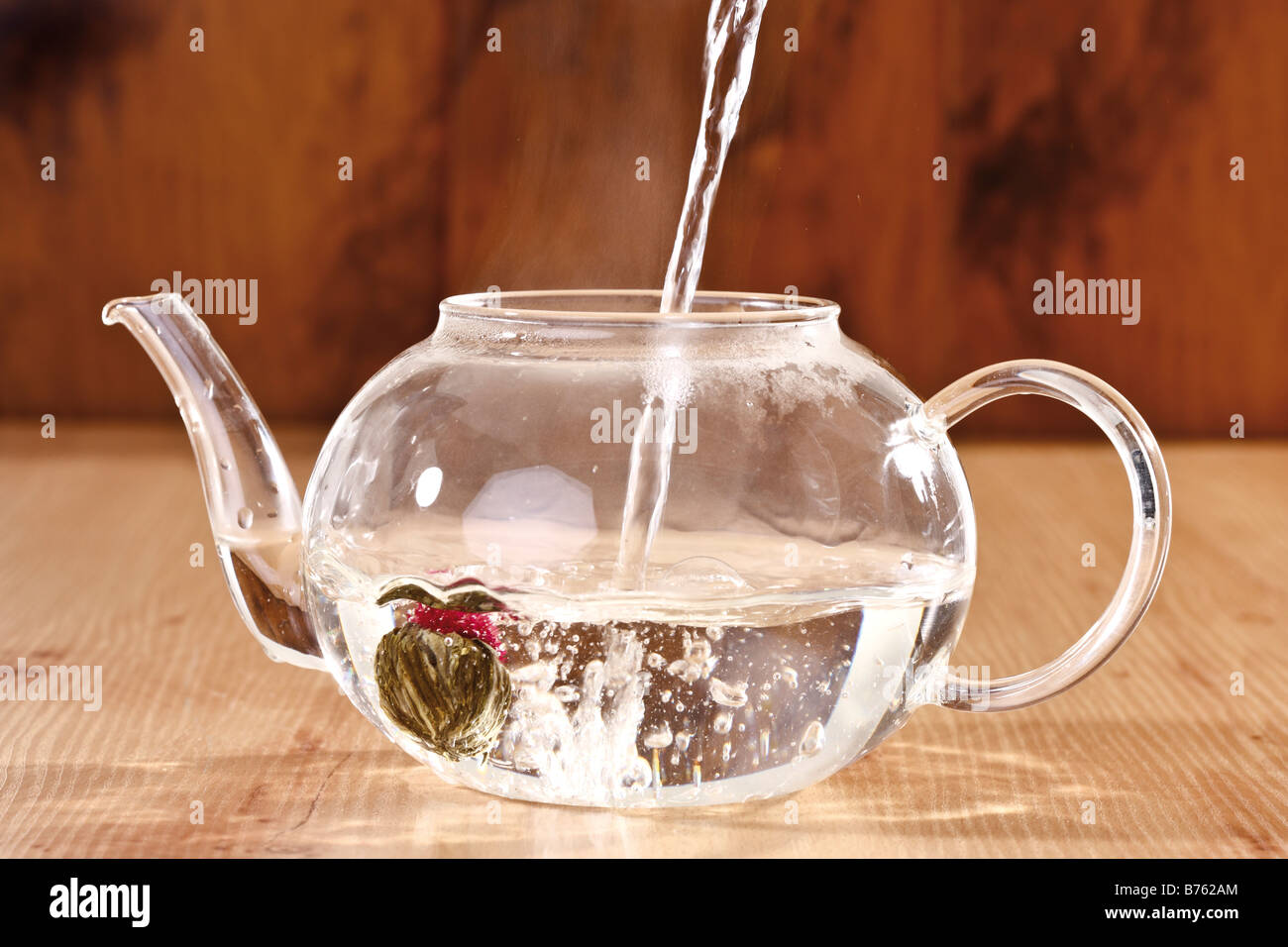Pouring hot water into Teapot, closeup Stock Photo Alamy